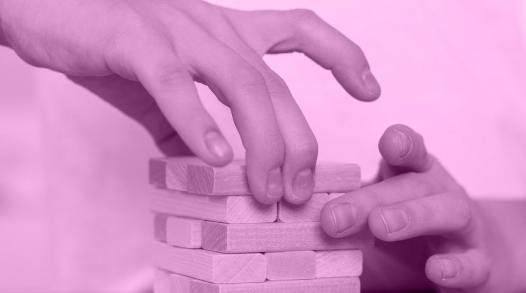 generic image featuring two hands stacking jenga game